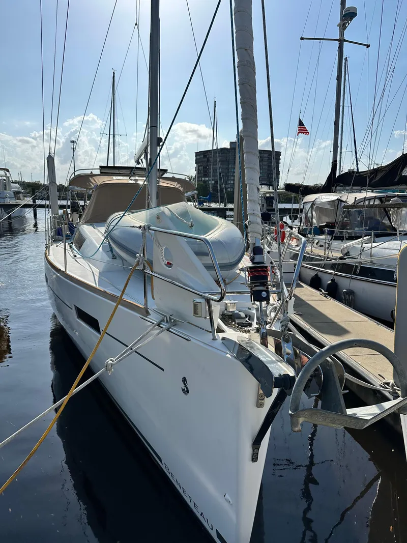 Slide: The Image of 2012 Beneteau Oceanis 41 sailboat docked in a marina under clear skies. - 80