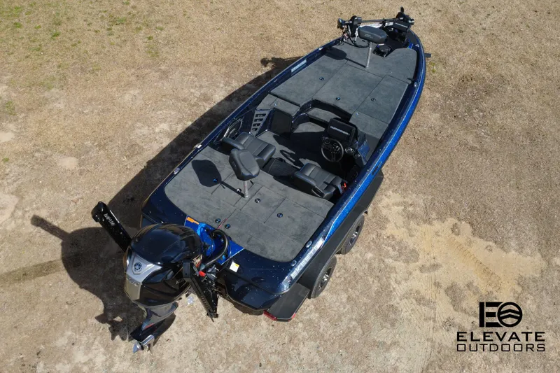 Slide: The Image of 2025 Skeeter ZXR 20 fishing boat, aerial view, on dry land, featuring dual seats and motor. - 2