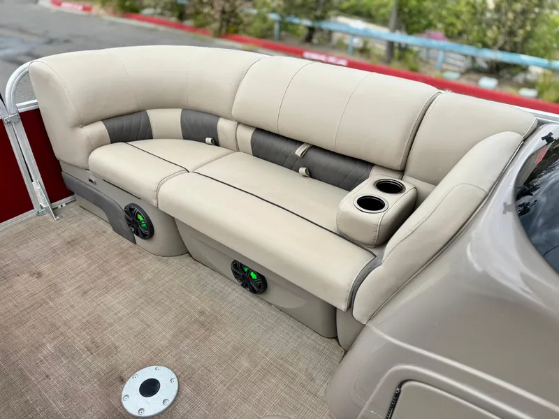Slide: The Image of 2021 Sun Tracker Party Barge 22 DLX XP3 interior seating with cup holders and speakers. - 10