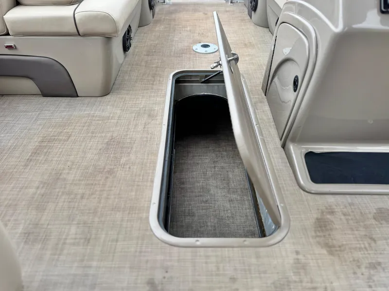 Slide: The Image of 2021 Sun Tracker Party Barge 22 DLX XP3 interior storage compartment open on deck. - 12
