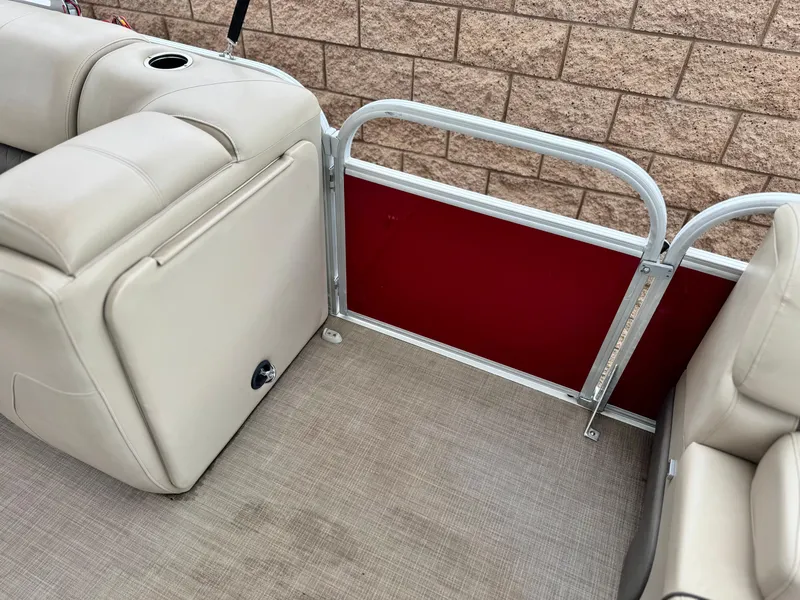 Slide: The Image of Interior of 2021 Sun Tracker Party Barge 22 DLX XP3 with beige seating and red panel. - 14