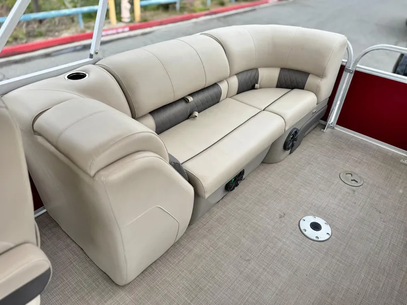 Slide: The Image of 2021 Sun Tracker Party Barge 22 DLX XP3 interior with beige seating and cup holder. - 16