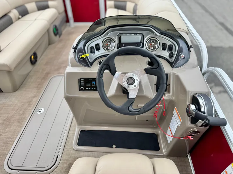 Slide: The Image of 2021 Sun Tracker Party Barge 22 DLX XP3 steering console with modern controls and seating. - 18