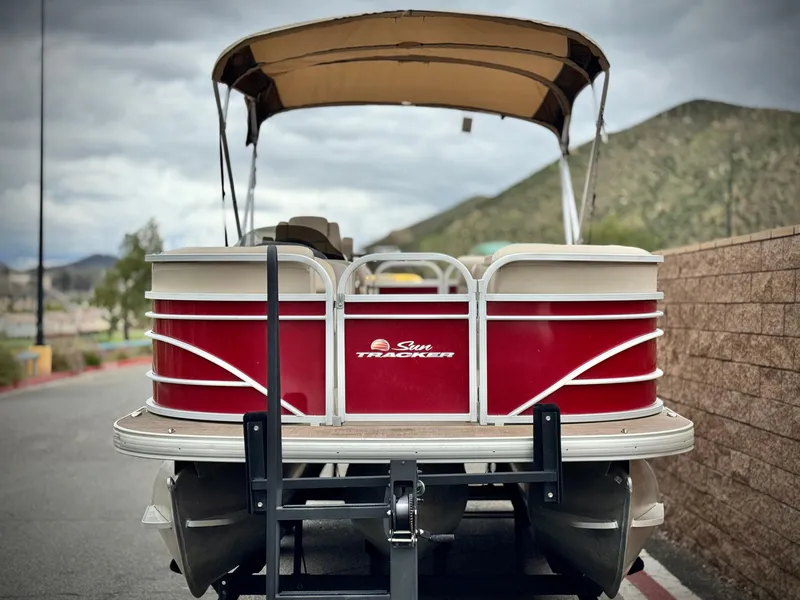 Slide: The Image of 2021 Sun Tracker Party Barge 22 DLX XP3 pontoon boat with canopy, parked on trailer. - 2