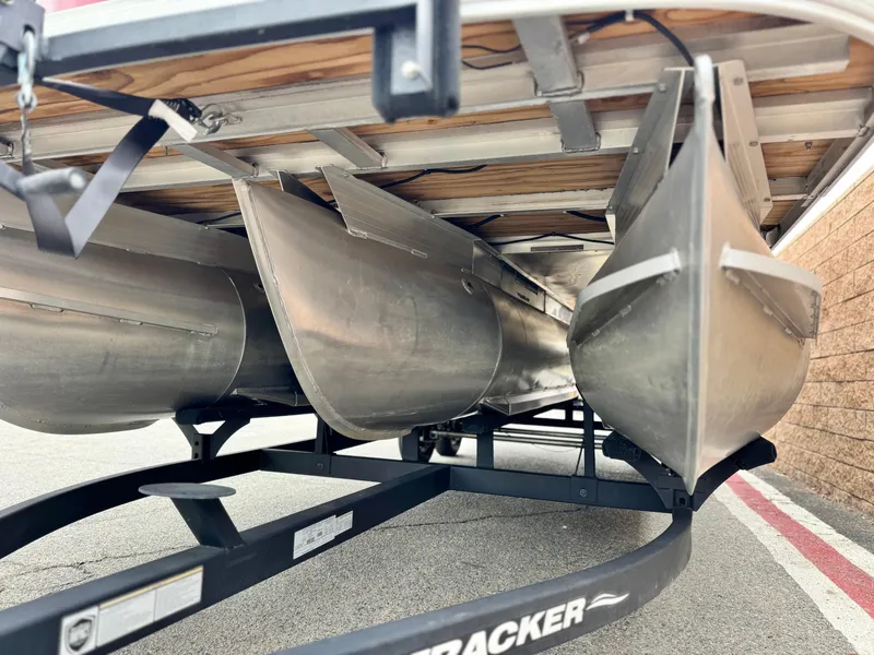 Slide: The Image of 2021 Sun Tracker Party Barge 22 DLX XP3 pontoon boat on trailer, underside view. - 3