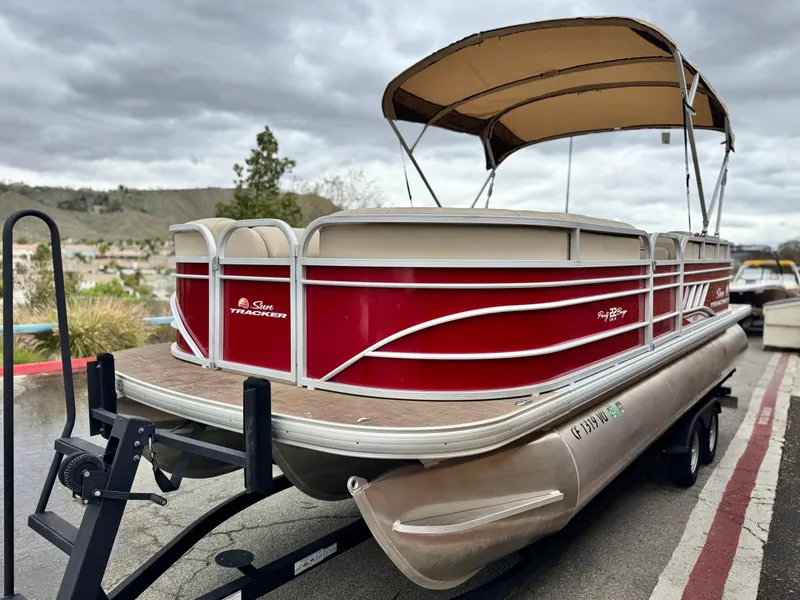 Slide: The Image of 2021 Sun Tracker Party Barge 22 DLX XP3 pontoon boat with canopy on trailer. - 4