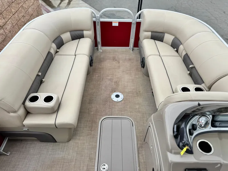 Slide: The Image of 2021 Sun Tracker Party Barge 22 DLX XP3 interior with beige seating and cup holders. - 8