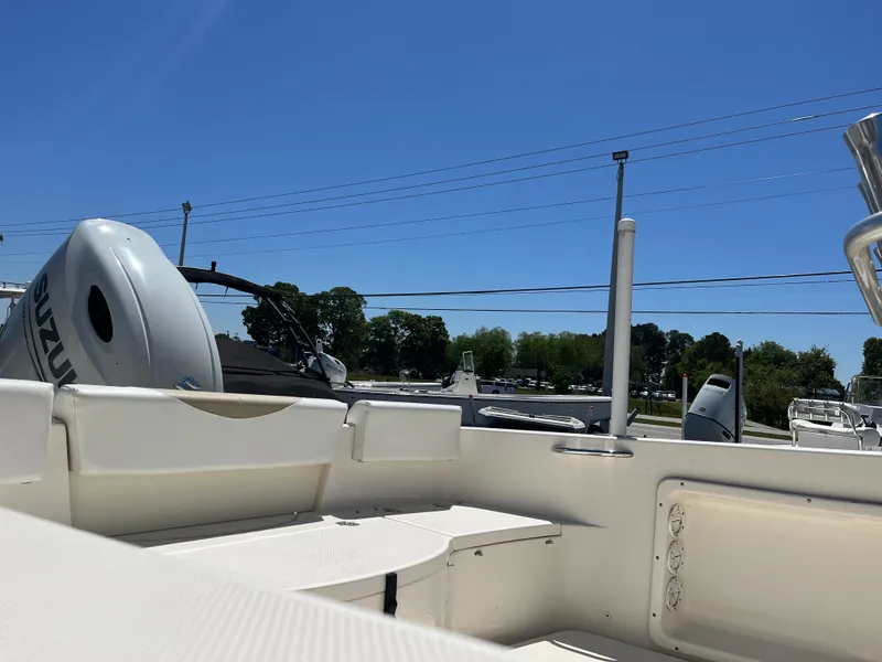 Slide: The Image of 2020 Bulls Bay 230 Center Console boat interior with Suzuki outboard motor under clear blue sky. - 10