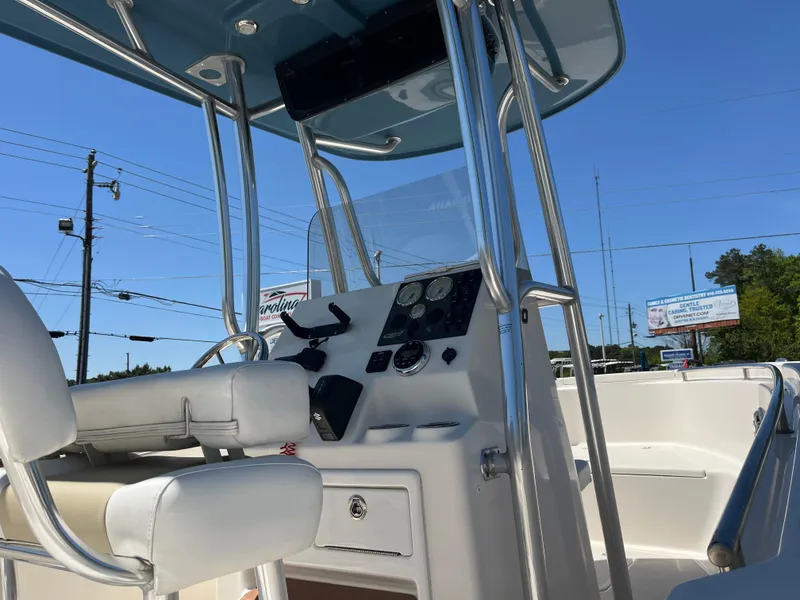 Slide: The Image of 2020 Bulls Bay 230 Center Console boat interior with steering wheel and controls. - 11