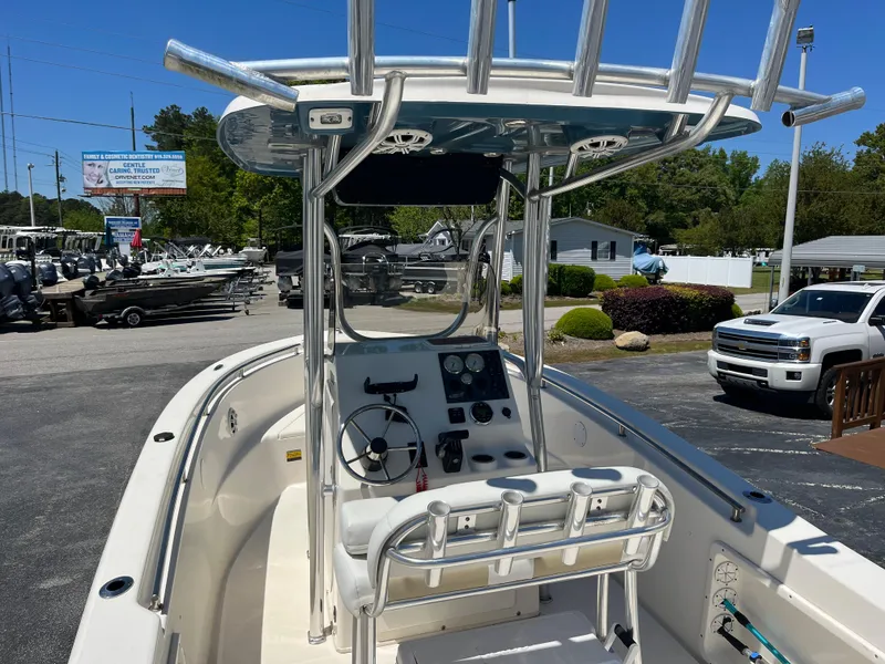 Slide: The Image of 2020 Bulls Bay 230 Center Console boat with T-top and steering console in a dealership lot. - 13