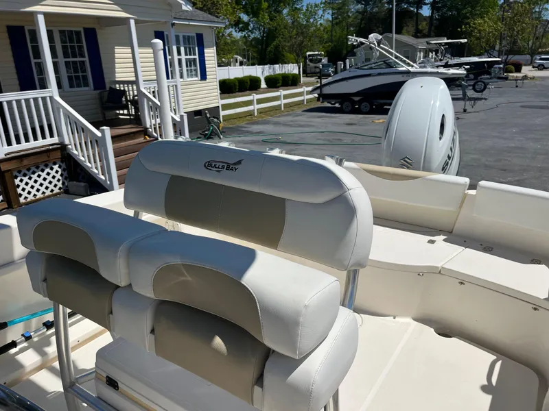 Slide: The Image of 2020 Bulls Bay 230 Center Console boat with seating and motor, parked outdoors. - 14
