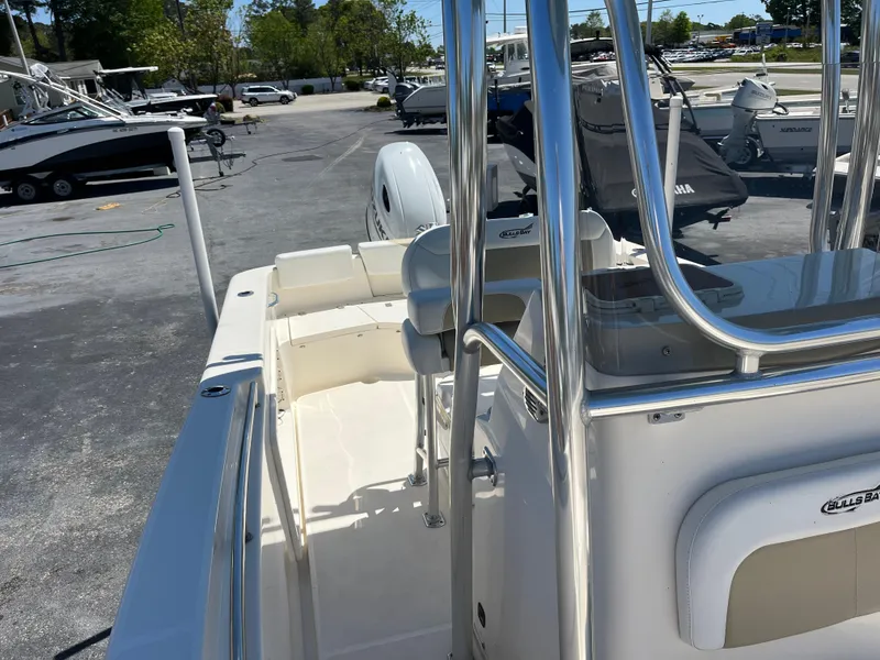 Slide: The Image of 2020 Bulls Bay 230 Center Console boat with sleek design in a marina setting. - 19