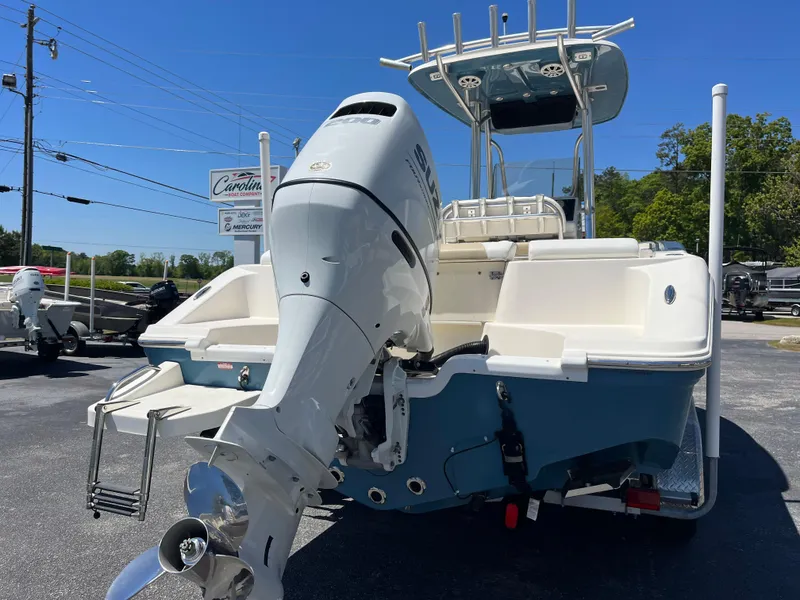 Slide: The Image of 2020 Bulls Bay 230 Center Console boat with outboard motor, parked outdoors. - 2