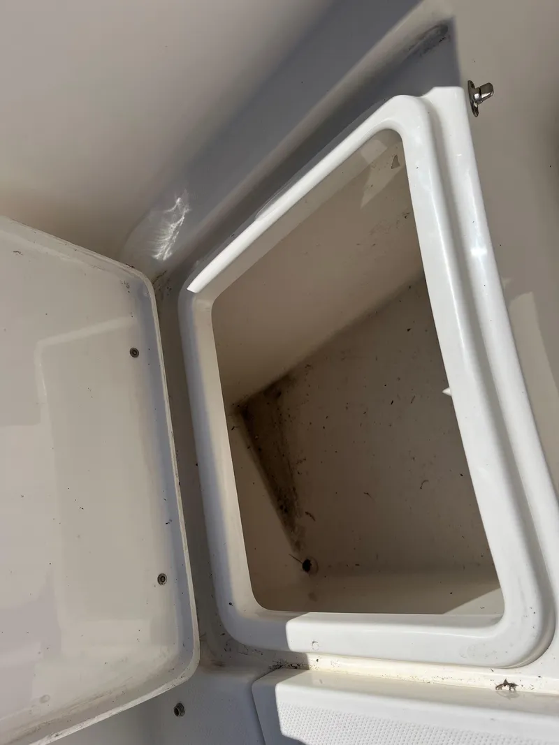 Slide: The Image of Open storage compartment on a 2020 Bulls Bay 230 Center Console boat. - 25