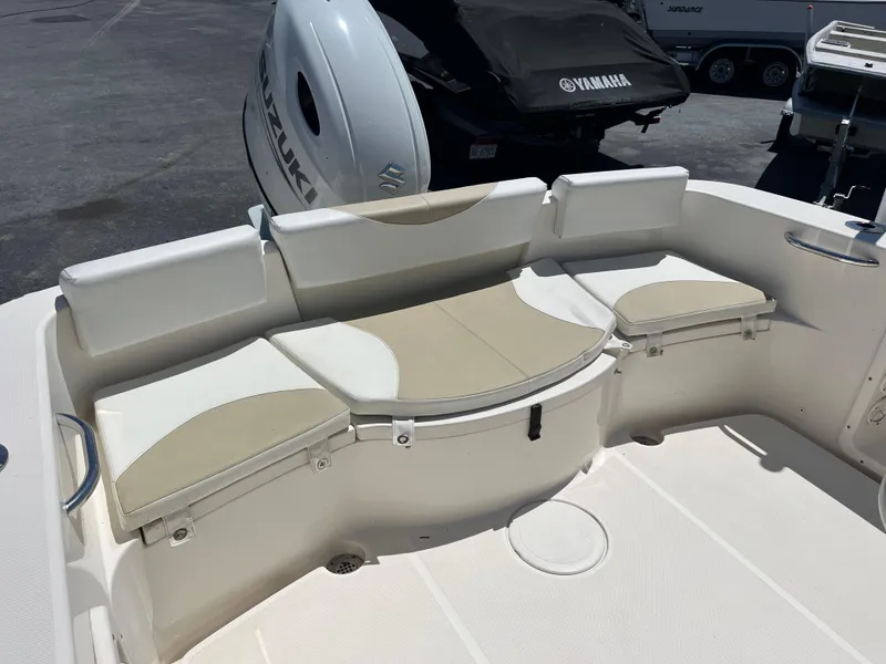 Slide: The Image of 2020 Bulls Bay 230 Center Console boat seating area with beige and white cushions. - 26