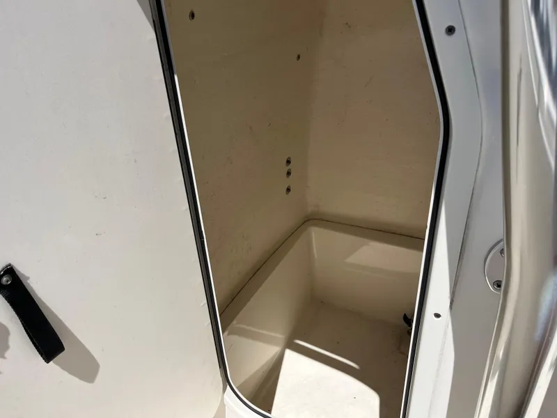 Slide: The Image of 2020 Bulls Bay 230 Center Console storage compartment, open and empty. - 27