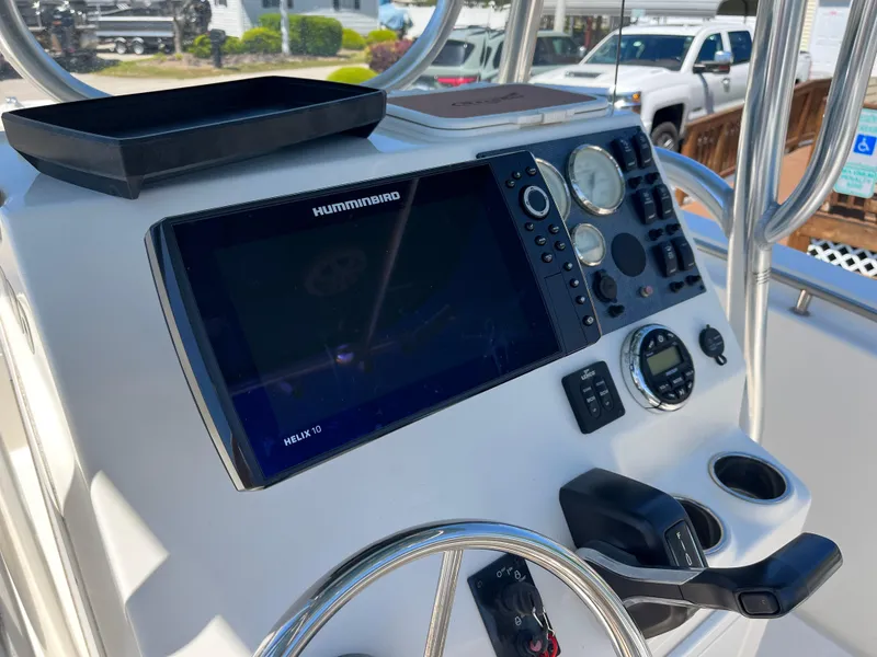 Slide: The Image of 2020 Bulls Bay 230 Center Console dashboard with Humminbird electronics and steering wheel. - 28