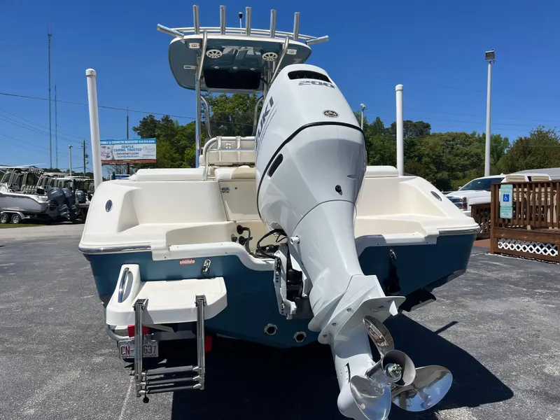 Slide: The Image of 2020 Bulls Bay 230 Center Console boat with powerful outboard motor, parked outdoors. - 3