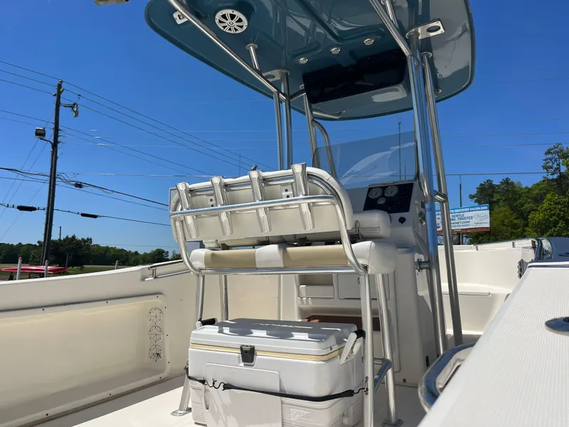 Slide: The Image of 2020 Bulls Bay 230 Center Console boat with T-top and seating, under clear blue sky. - 9
