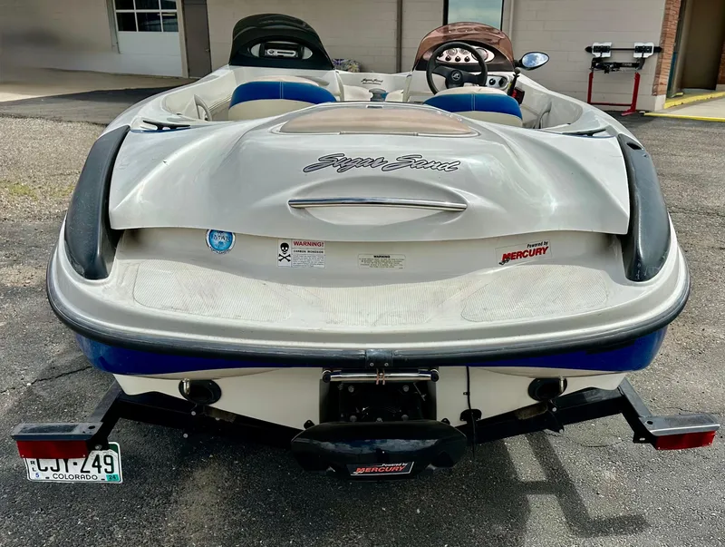 Slide: The Image of 2007 Tango Super Sport boat, rear view, parked outdoors with visible license plate and Mercury branding. - 3