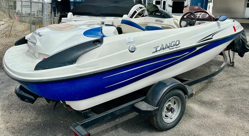 Slide: The Image of 2007 Tango Super Sport boat on trailer, featuring sleek blue and white design. - 4
