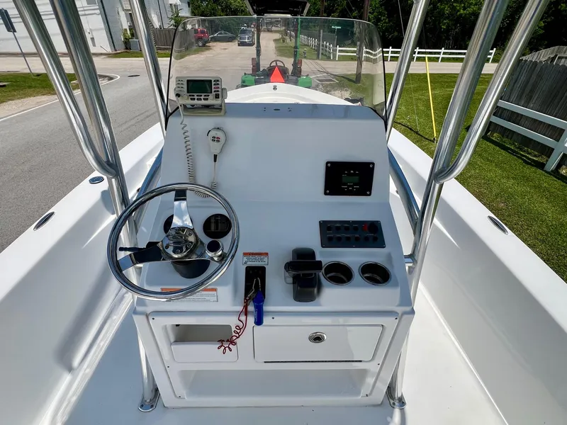 Slide: The Image of 2013 Sportsman Masters 227 Bay Boat console with steering wheel and navigation equipment. - 11
