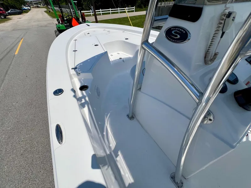 Slide: The Image of 2013 Sportsman Masters 227 Bay Boat, white deck, parked on a street. - 13
