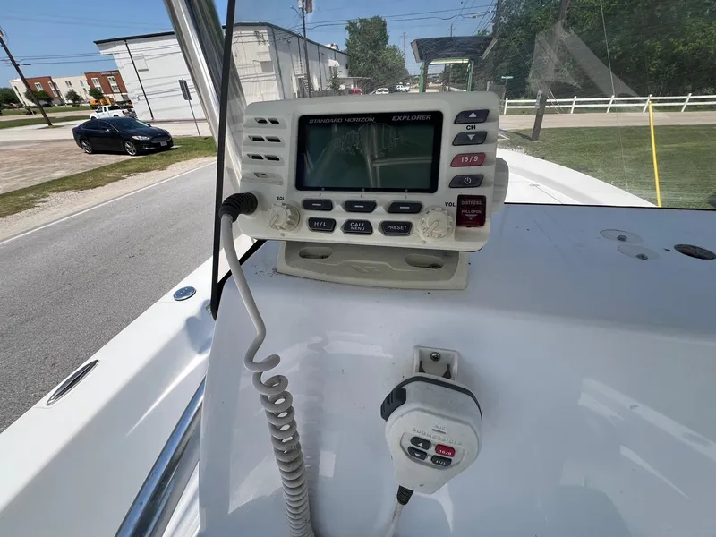 Slide: The Image of 2013 Sportsman Masters 227 Bay Boat console with marine radio and controls. - 18