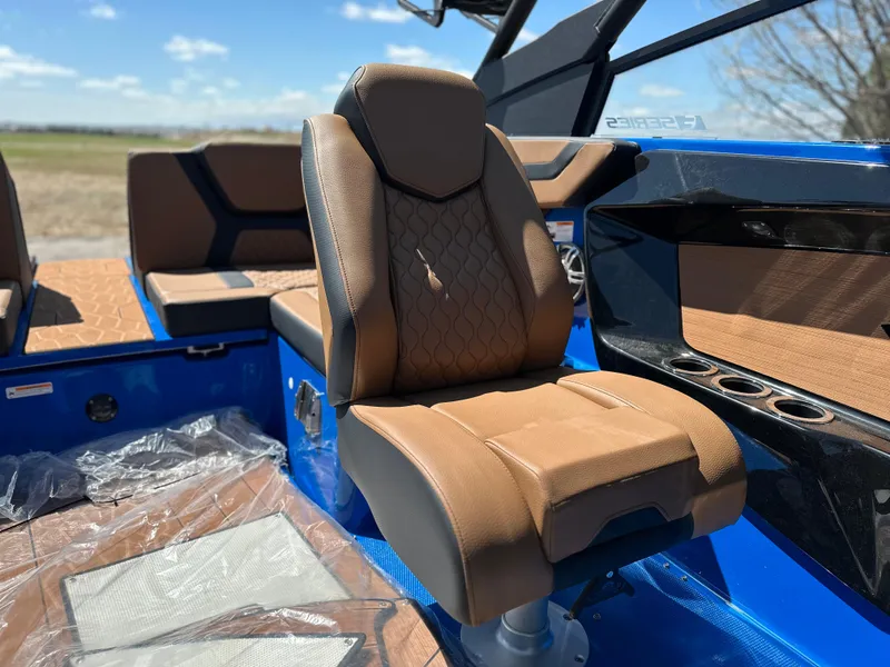 Slide: The Image of 2025 Yamaha Boats 222XE interior with brown seating and blue accents. - 11