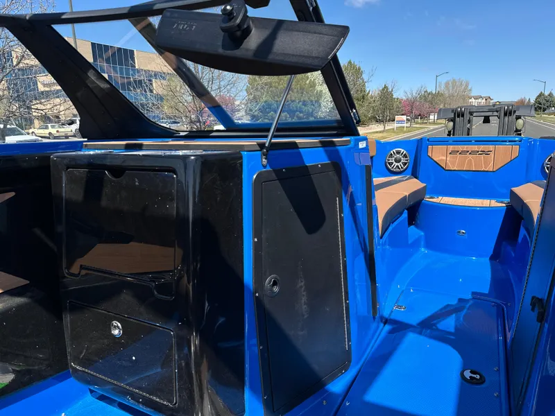 Slide: The Image of 2025 Yamaha Boats 222XE interior, featuring blue and black design with seating and storage. - 12