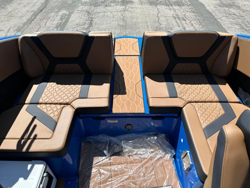 Slide: The Image of 2025 Yamaha Boats 222XE interior with brown and black seating, blue accents. - 14