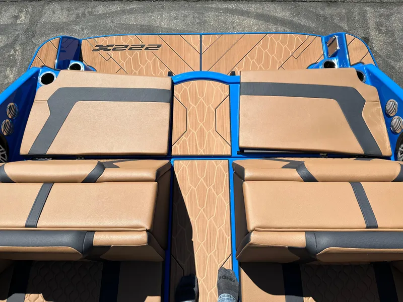 Slide: The Image of 2025 Yamaha Boats 222XE interior with tan and blue seating, showcasing modern design. - 15