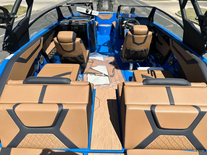 Slide: The Image of 2025 Yamaha Boats 222XE interior with tan and black seating, blue accents, and modern design. - 16