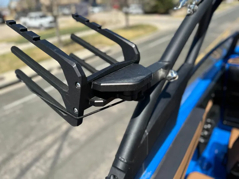 Slide: The Image of 2025 Yamaha Boats 222XE wakeboard rack on blue boat, close-up view. - 17