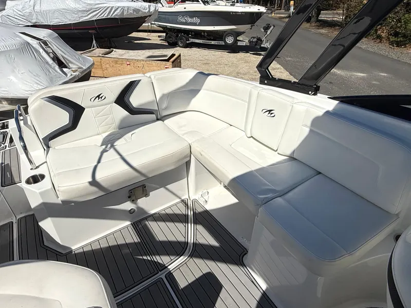 Slide: The Image of 2014 Monterey M5 Sport Boat with white cushioned seating in outdoor setting. - 16