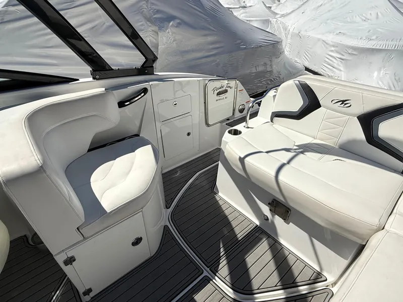 Slide: The Image of 2014 Monterey M5 Sport Boat interior with white seating and sleek design. - 18