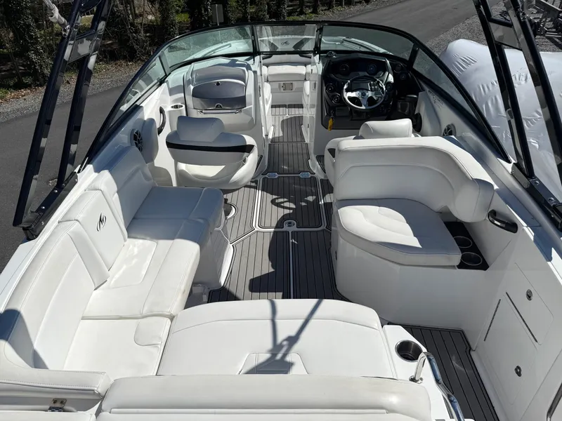Slide: The Image of 2014 Monterey M5 Sport Boat interior with white seating and sleek design. - 19