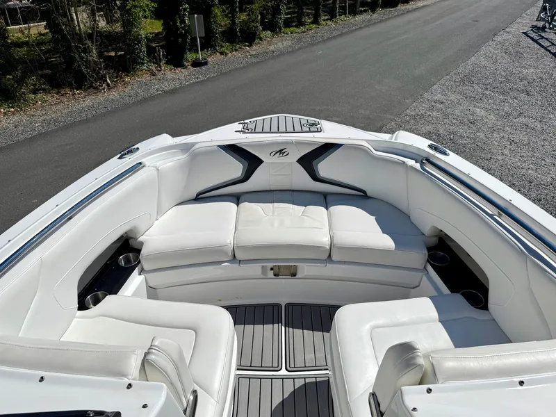 Slide: The Image of 2014 Monterey M5 Sport Boat with white seating and sleek design on a sunny day. - 6