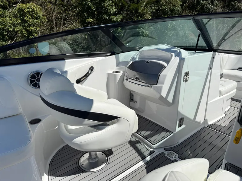 Slide: The Image of 2014 Monterey M5 Sport Boat interior with white seating and sleek dashboard design. - 9