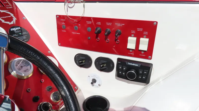 Slide: The Image of Control panel of a 2002 Fountain 47 Lightning boat with switches and gauges. - 11