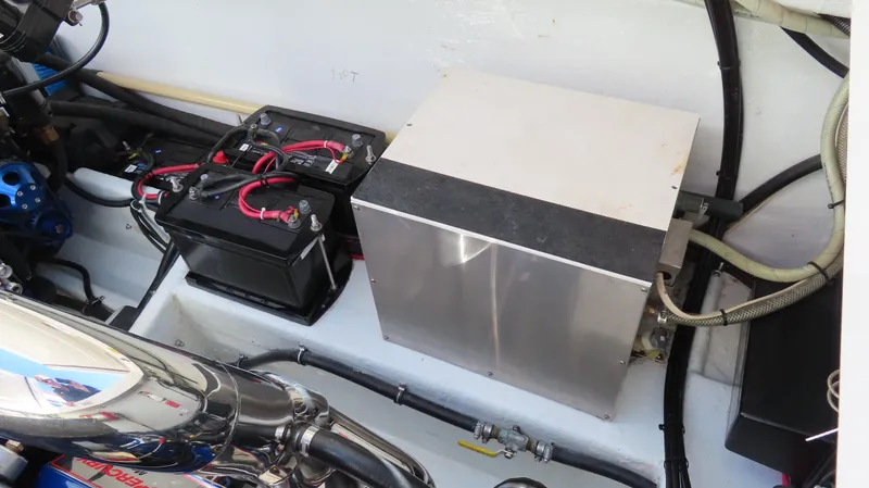 Slide: The Image of Engine compartment of a 2002 Fountain 47 Lightning boat, featuring batteries and wiring. - 18