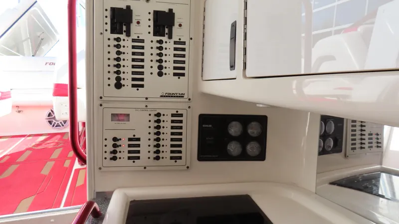 Slide: The Image of Control panel of a 2002 Fountain 47 Lightning boat, featuring switches and gauges. - 20