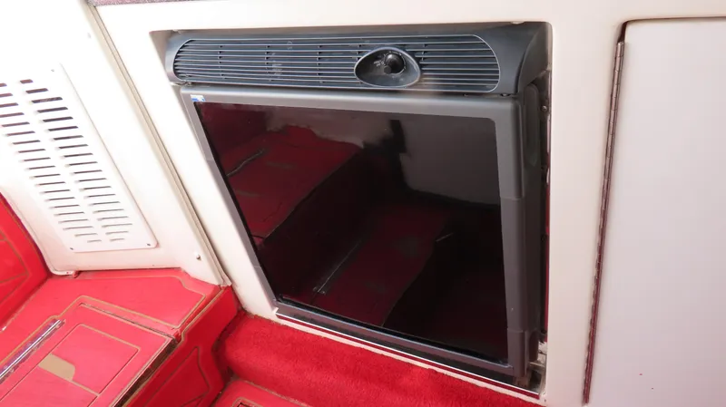 Slide: The Image of 2002 Fountain 47 Lightning interior with red carpet and built-in mini fridge. - 22