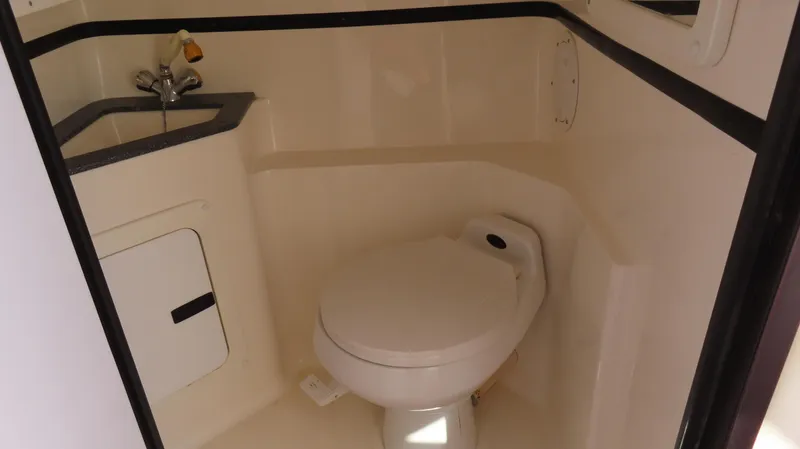 Slide: The Image of 2002 Fountain 47 Lightning boat bathroom with toilet and sink. - 23