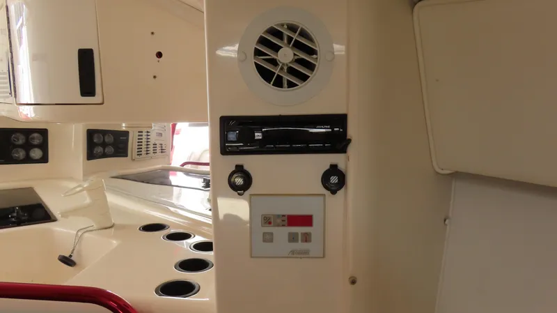 Slide: The Image of Interior of 2002 Fountain 47 Lightning boat with control panel and cup holders. - 25
