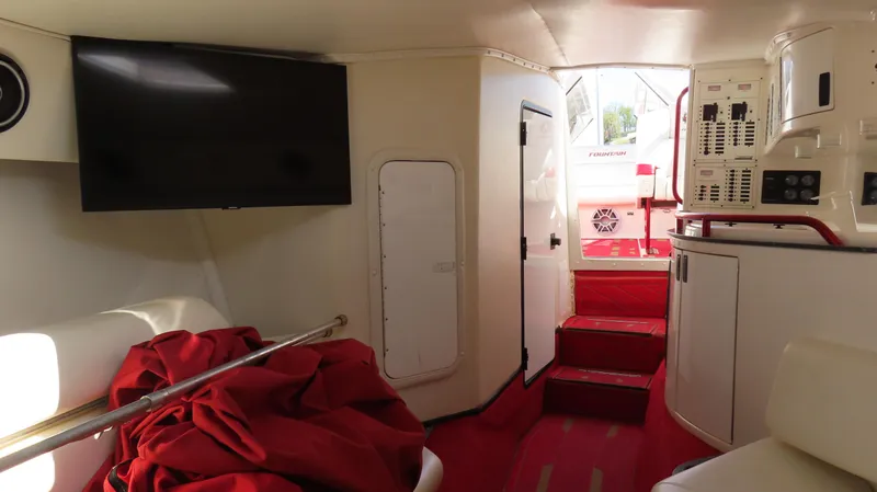 Slide: The Image of Interior of 2002 Fountain 47 Lightning boat with red carpet and TV. - 26