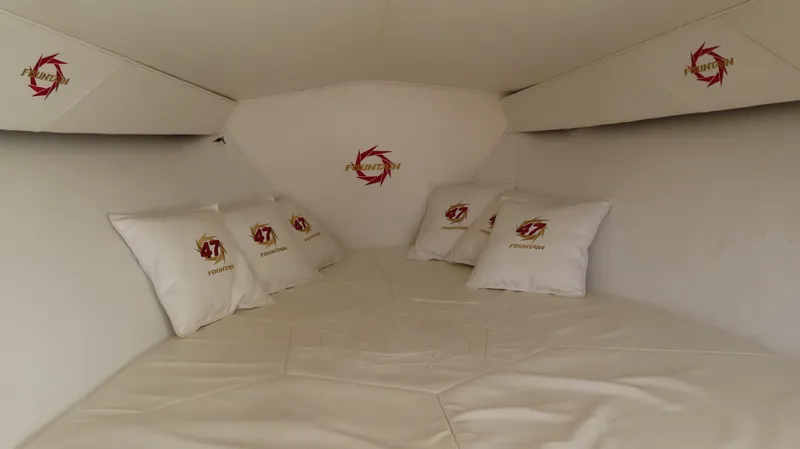 Slide: The Image of Interior cabin of 2002 Fountain 47 Lightning boat with branded pillows and white bedding. - 28