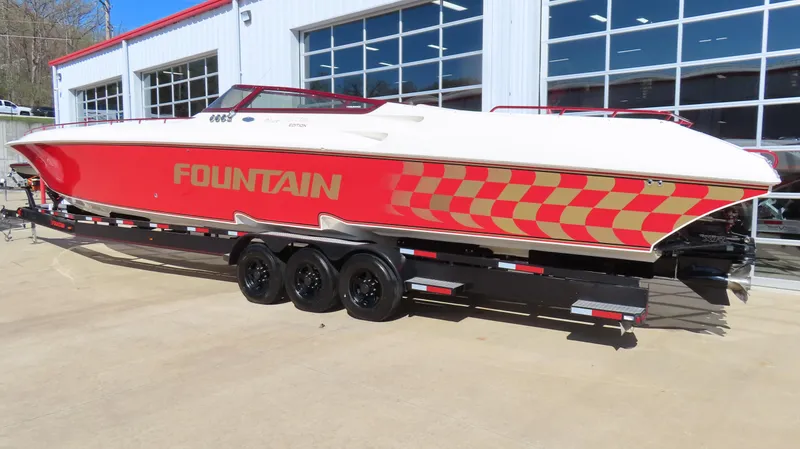 Slide: The Image of 2002 Fountain 47 Lightning speedboat with red and white design on a trailer. - 3
