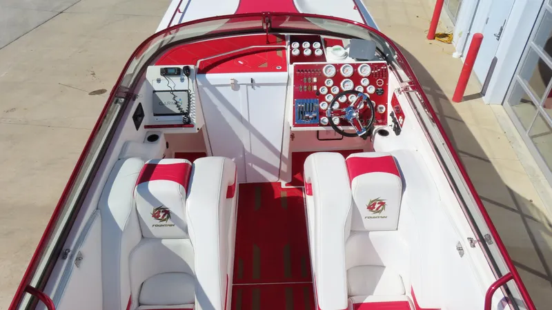Slide: The Image of 2002 Fountain 47 Lightning boat interior with red and white seating and control panel. - 32