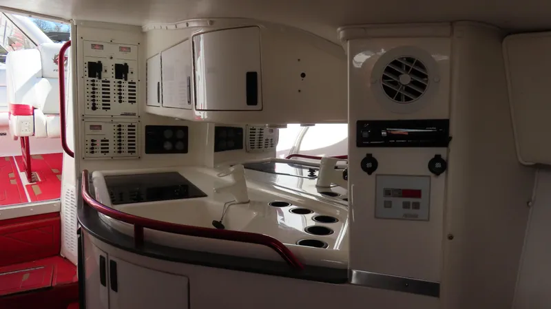 Slide: The Image of Interior of a 2002 Fountain 47 Lightning boat, featuring a compact kitchen area. - 37